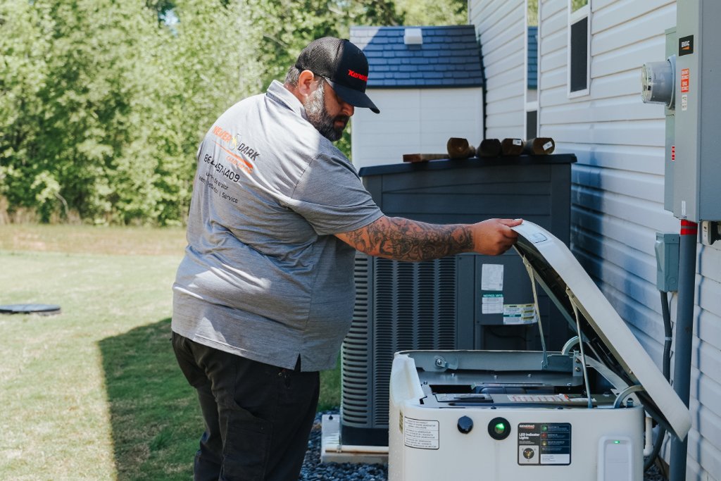 Never Dark Carolinas certified technician servicing a Generac standby generator in South Carolina