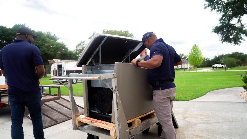 Maneuvering a standby unit into place — Never Dark Carolinas