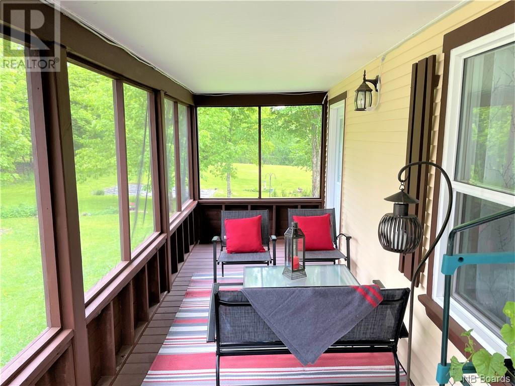Screened porch with seating area