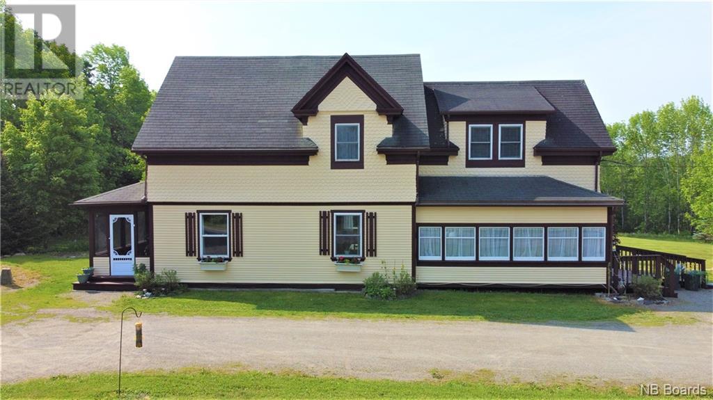Front of house with screened porch and landscaping
