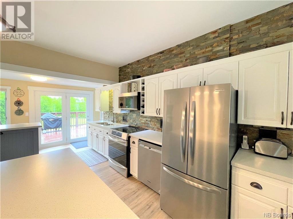 Full kitchen view with stone feature wall