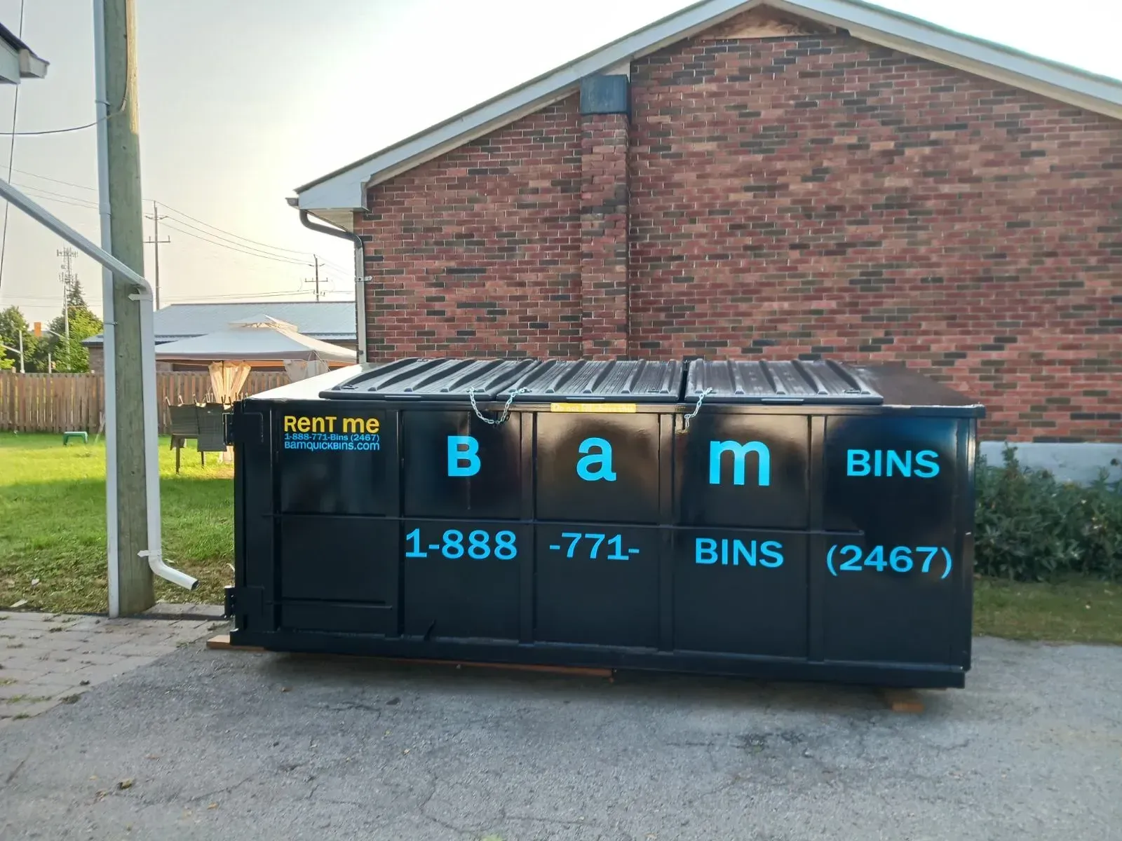 Black BAM commercial bin with teal lettering