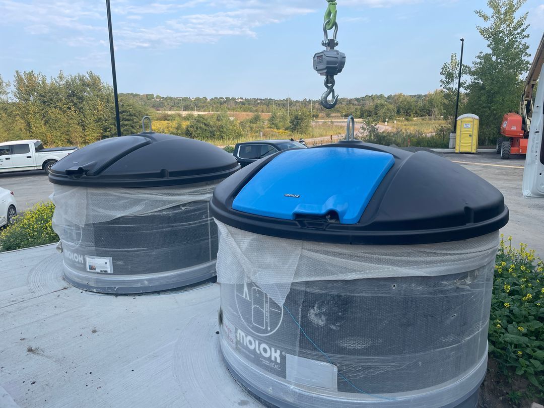 Molok semi in-ground bins being craned into place at an install site