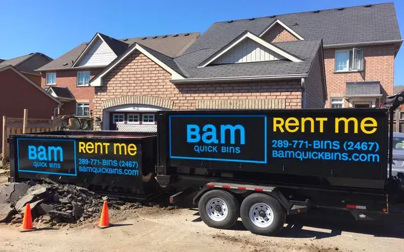 Black BAM residential bin trailer with signage