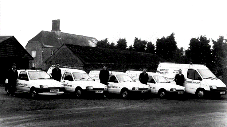 Five vans lined up at the yard — the Curtis and Carder livery from day one.