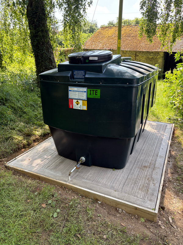 Professional oil tank installation next to an English countryside home