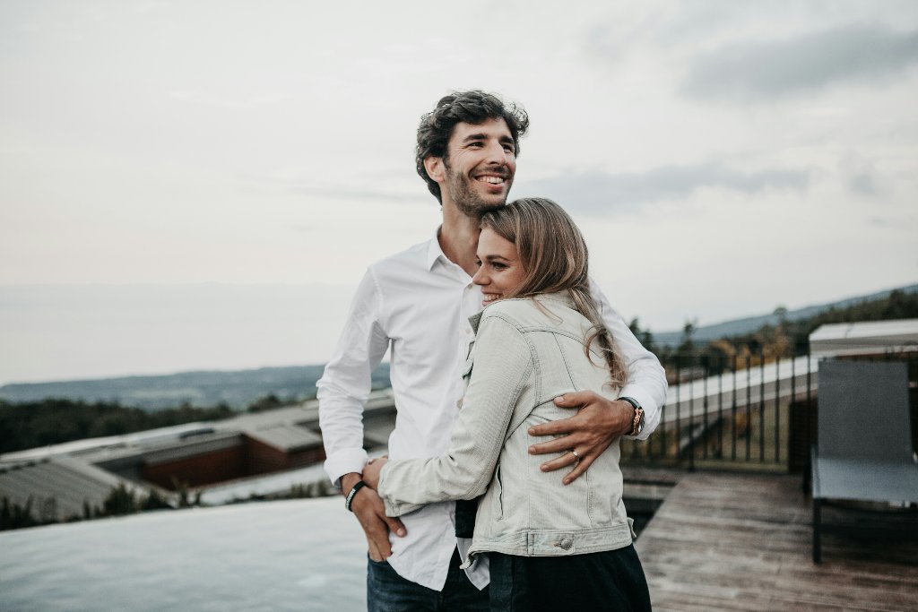 Engaged couple embracing outdoors