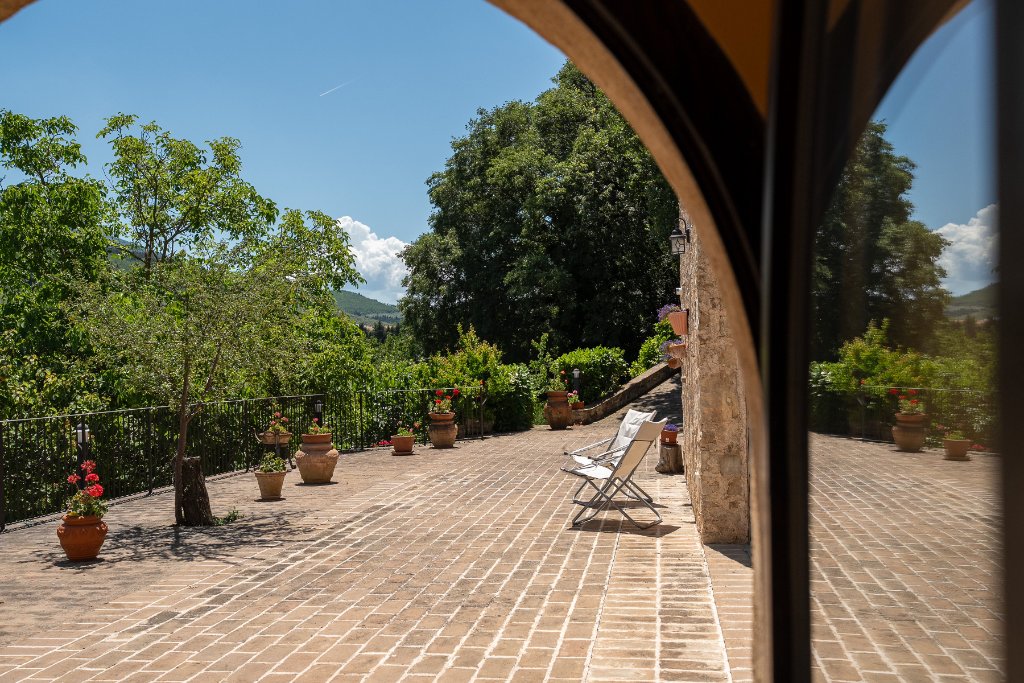Terrace view framed by stone arch
