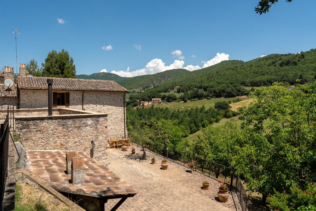 High-angle view of the house and terrace with countryside beyond