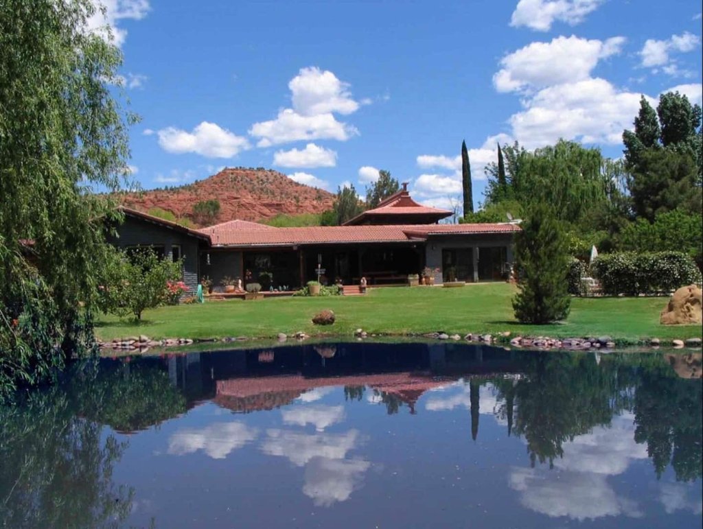 The reflecting pond mirroring the retreat house and sky