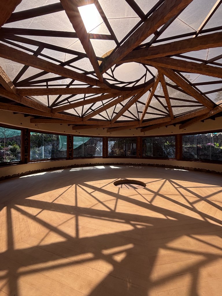 The domed yoga shala with a wooden-beam skylight