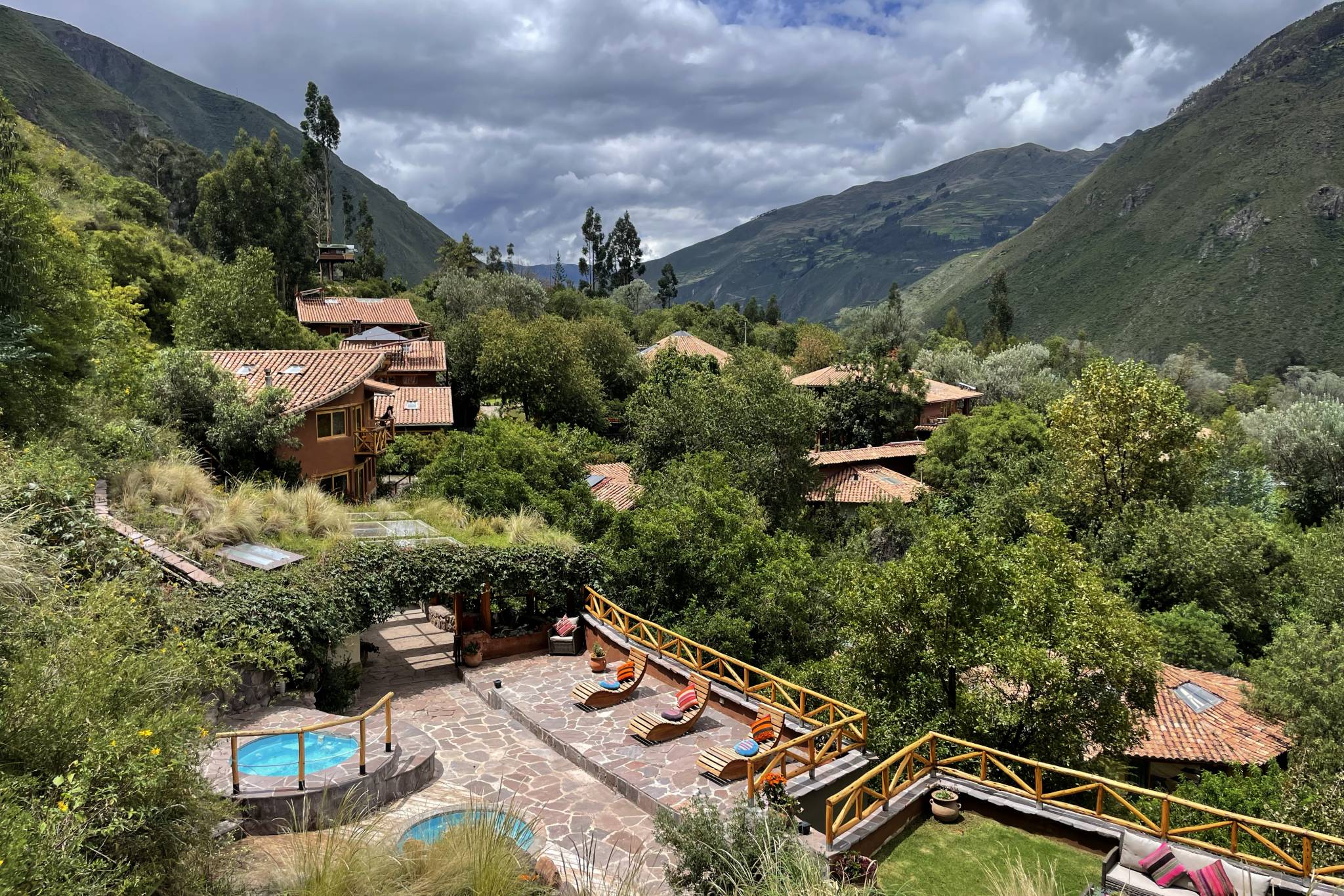 Outdoor hot pools and lounge chairs at the Qhalilla Spa retreat center in the Sacred Valley