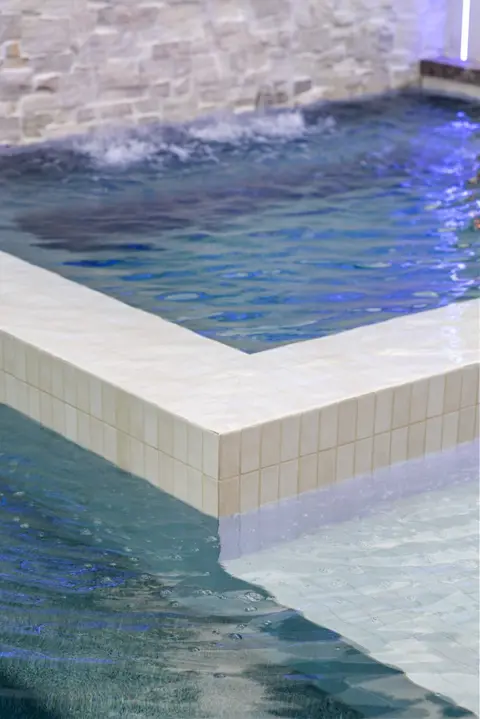 Full backyard view of a custom pool and spa with travertine decking in Huntington Beach, CA