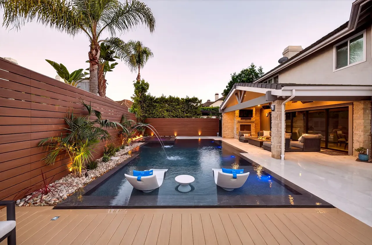 Luxury estate pool with fire pit, spa, and outdoor living features in Huntington Beach