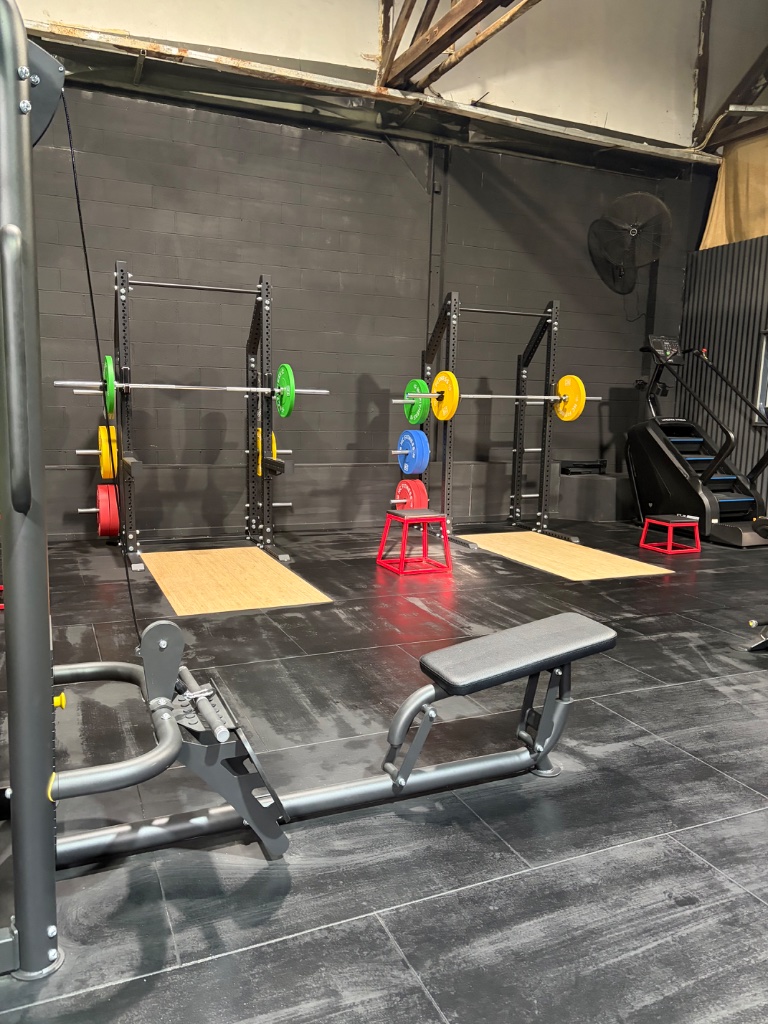 Gym training floor with squat racks and equipment