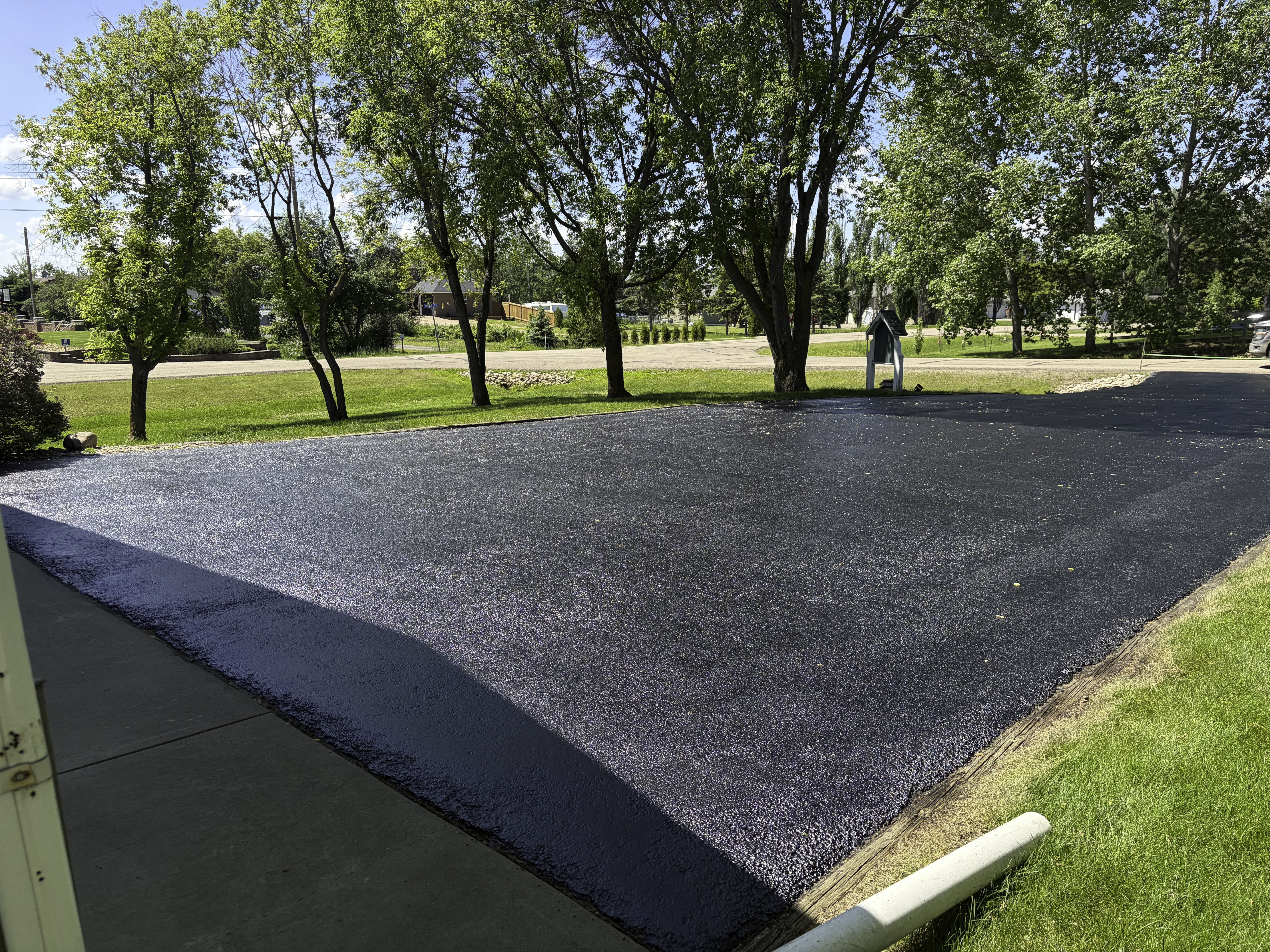 Slurry seal application restoring an asphalt driveway