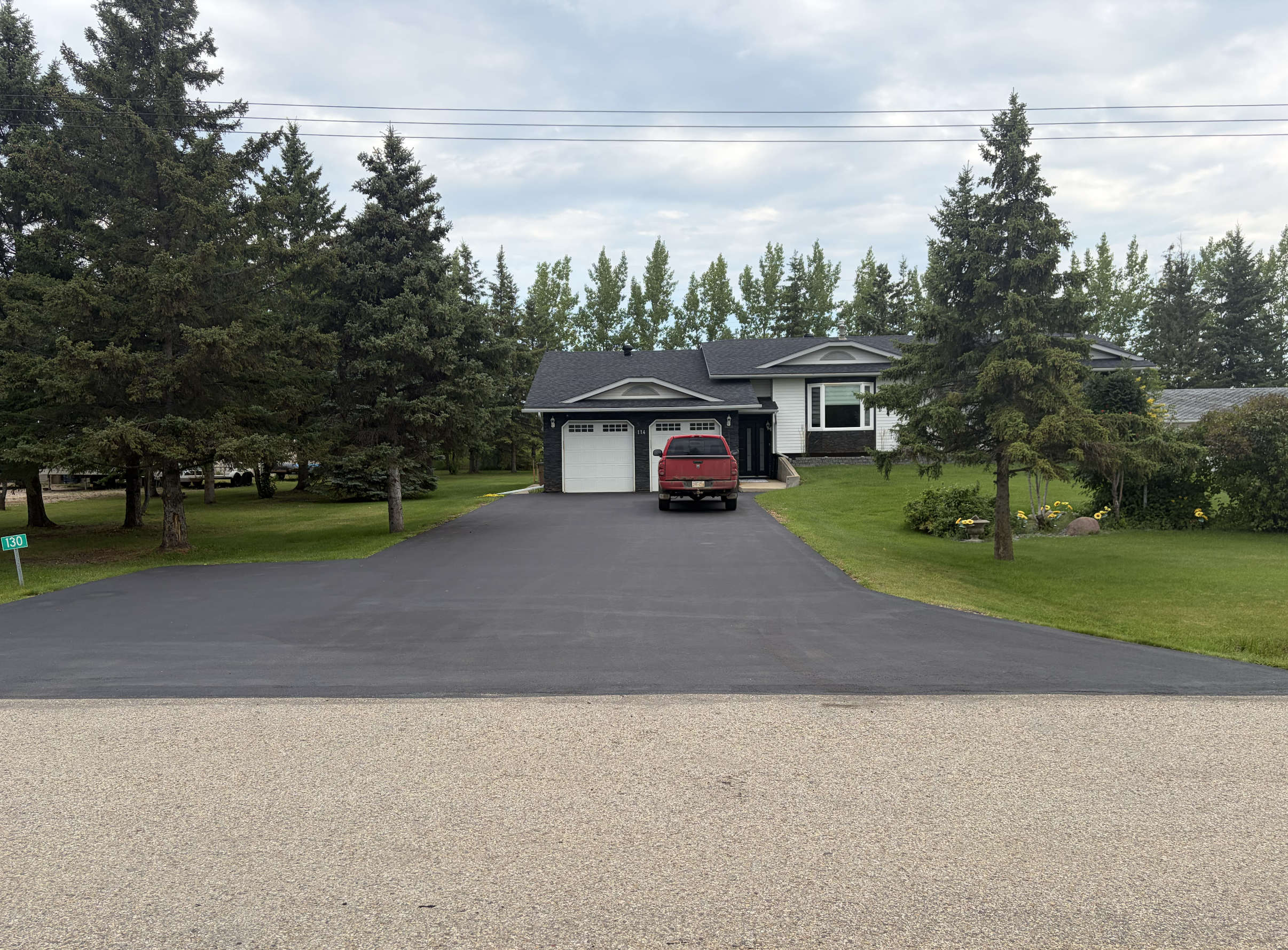 Same driveway with a fresh, uniform slurry seal finish