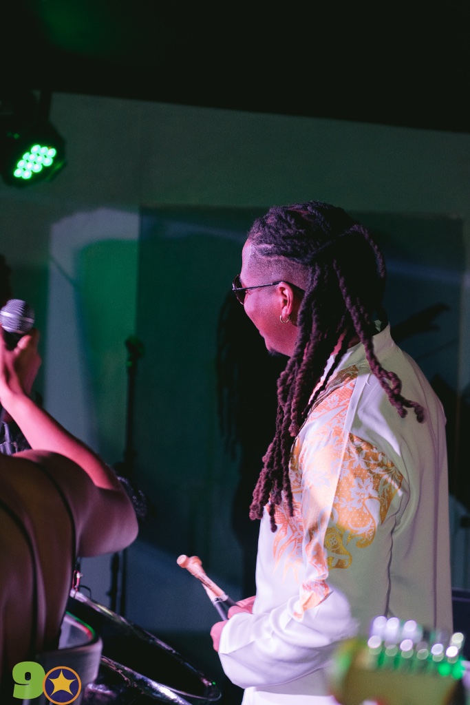 Kobie Alleyne on stage at his 2025 birthday show under purple and green stage lights