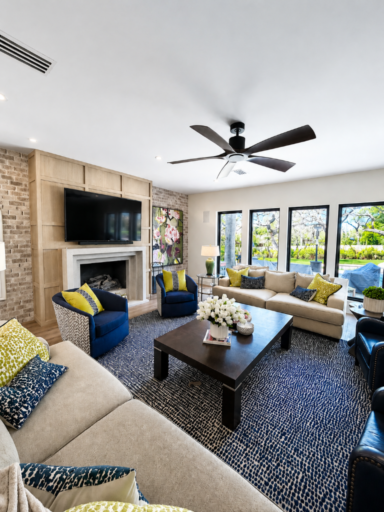 Dark wood paneling and heavy furniture replaced with a bright, modern living space
