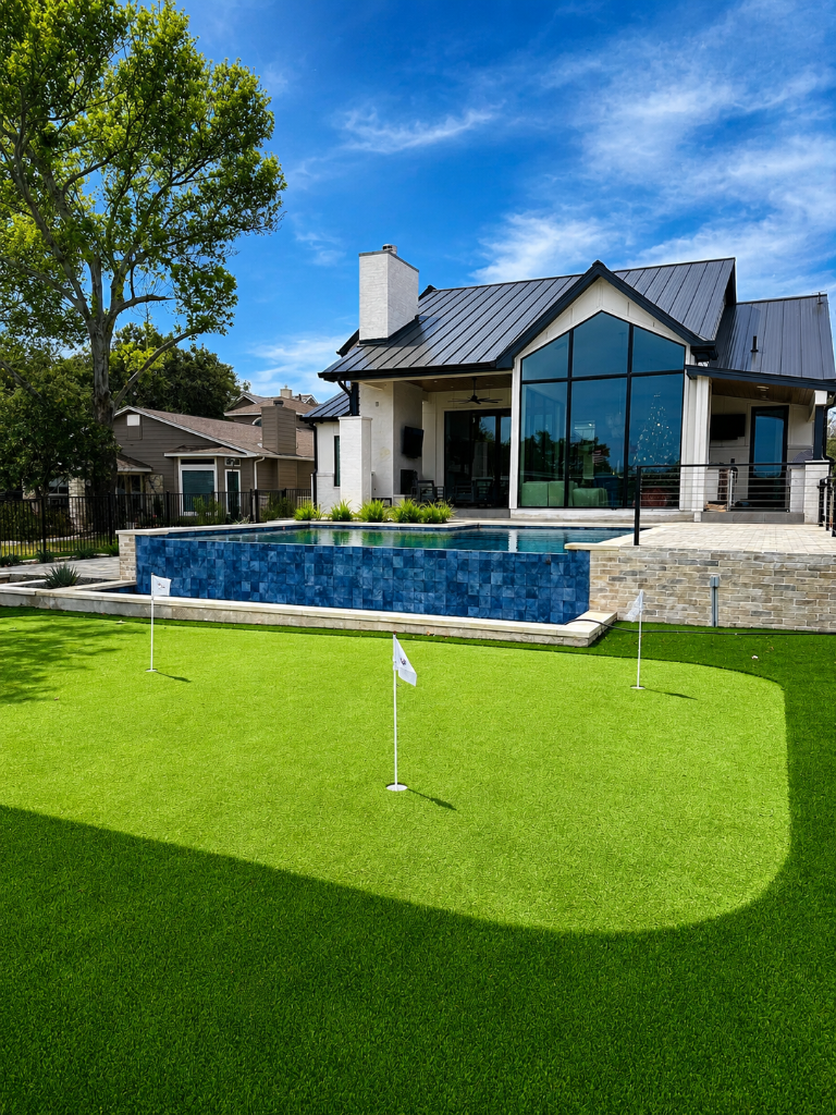 Custom new build on Lake LBJ featuring a putting green, infinity-edge pool, and modern farmhouse design