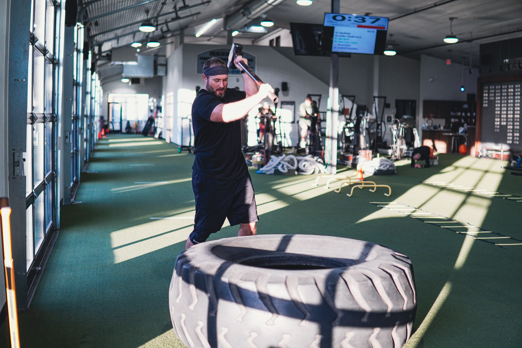 Athlete flipping a tractor tire during a MELT group fitness workout at Maximum Performance & Fitness in West Fargo, ND