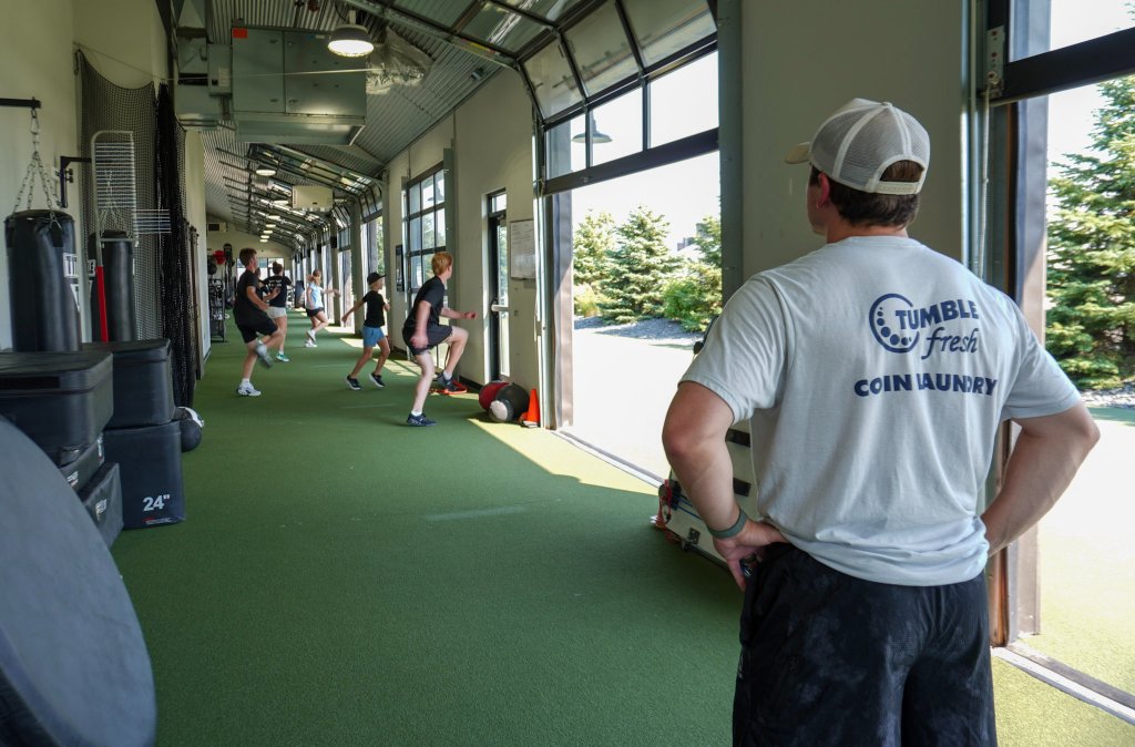 Group athletic training session inside the MPF turf facility