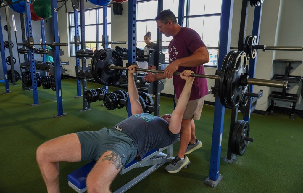 Personal training bench press session with spotter at Maximum Performance & Fitness West Fargo ND