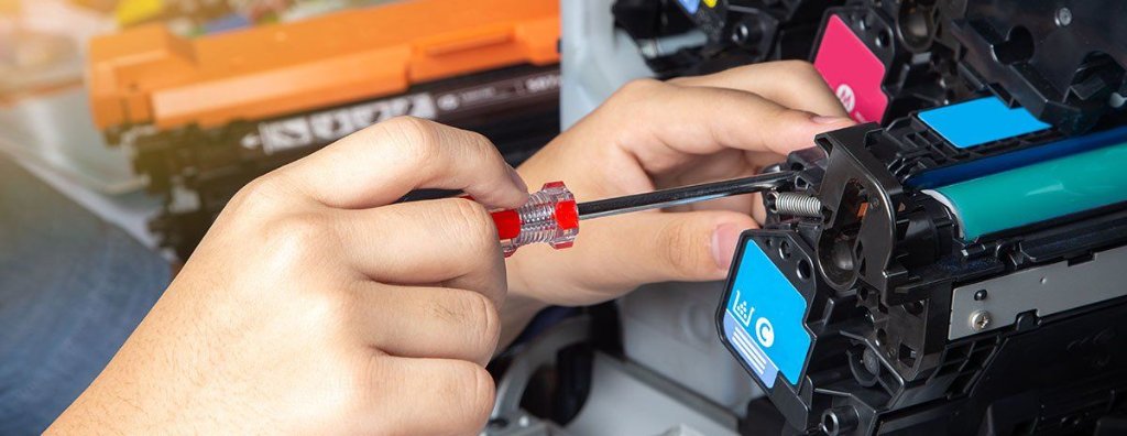 Technician repairing office equipment