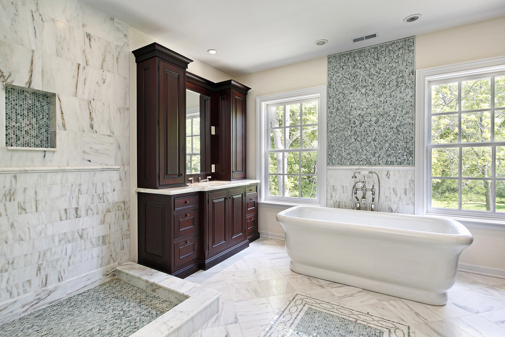 Luxury bathroom with dark wood double vanity, marble shower, and freestanding soaking tub