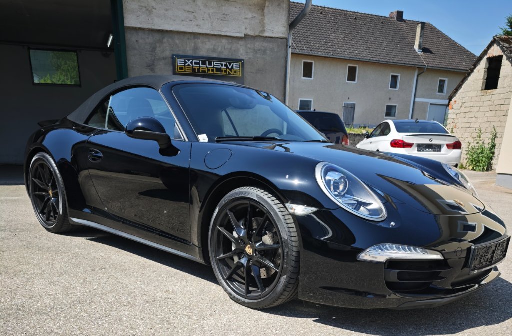 Luxury car in pristine detailing studio with perfect ceramic coating finish