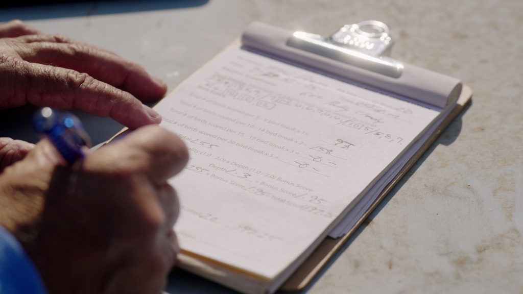 Judge filling out a competition scorecard