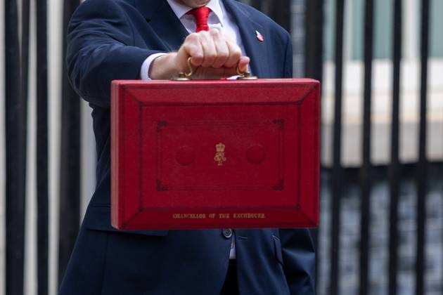 The red Chancellor of the Exchequer Budget box being held outside Downing Street