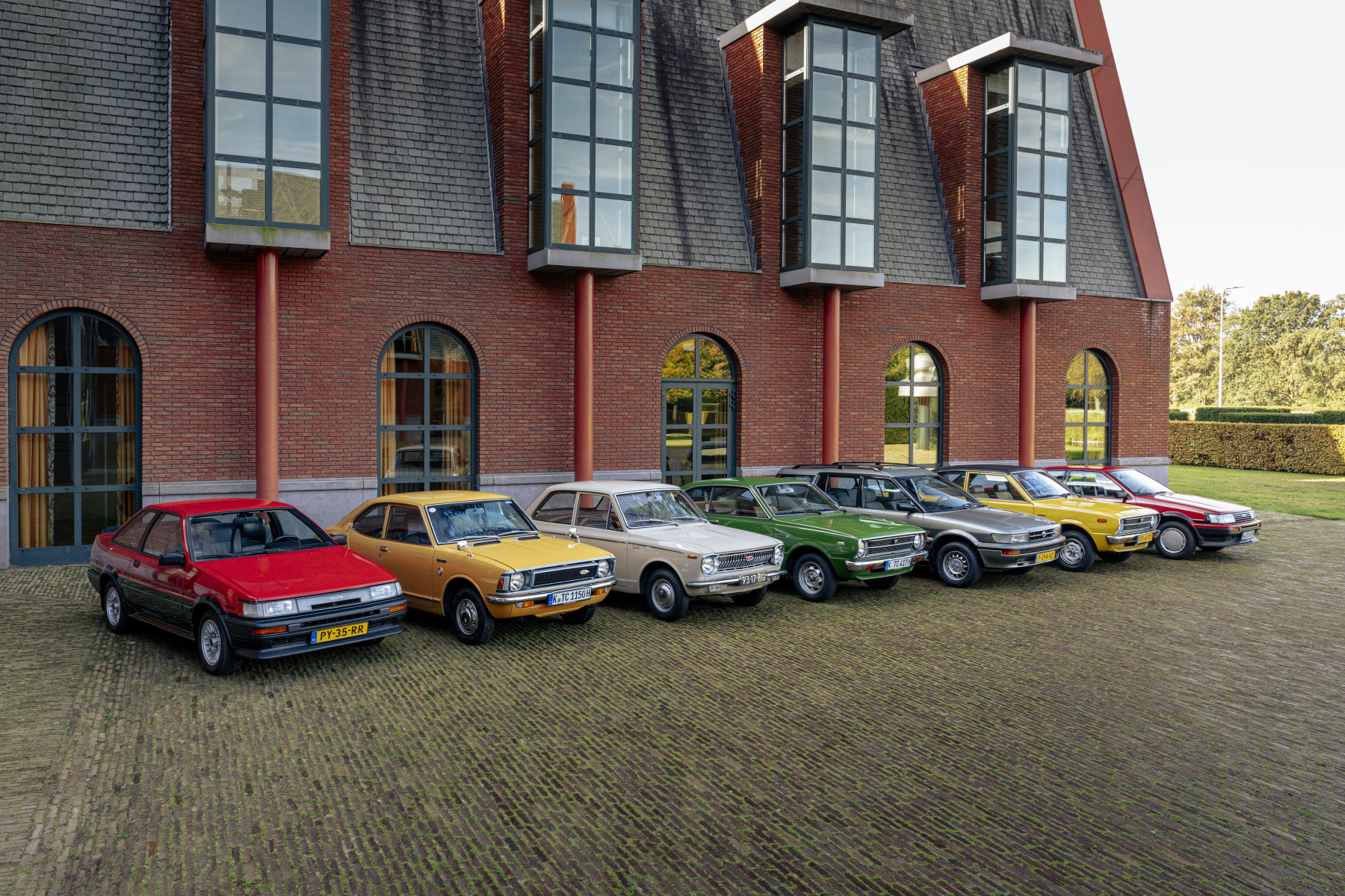 Historic Toyota Corolla generations lined up together to mark 60 years of the Corolla