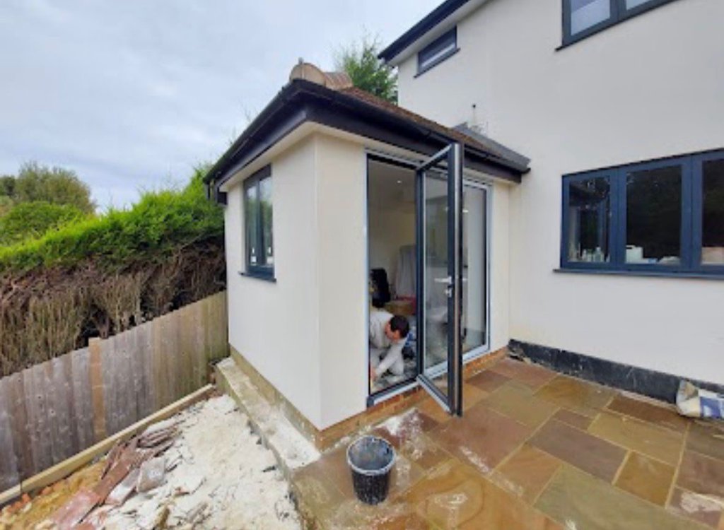 Completed monocouche render with bifold doors and patio