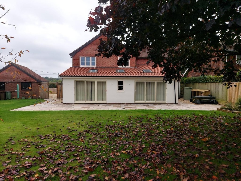 Ground floor render against existing tiled upper storey