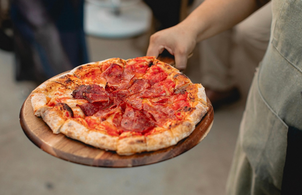 Freshly baked pepperoni pizza on a serving board