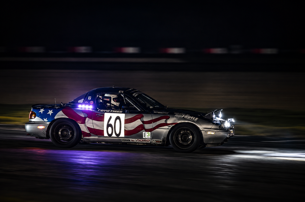 Spec Miata chasing through the headlights at Thunderhill