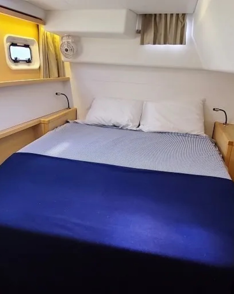 Cabin with blue duvet and porthole
