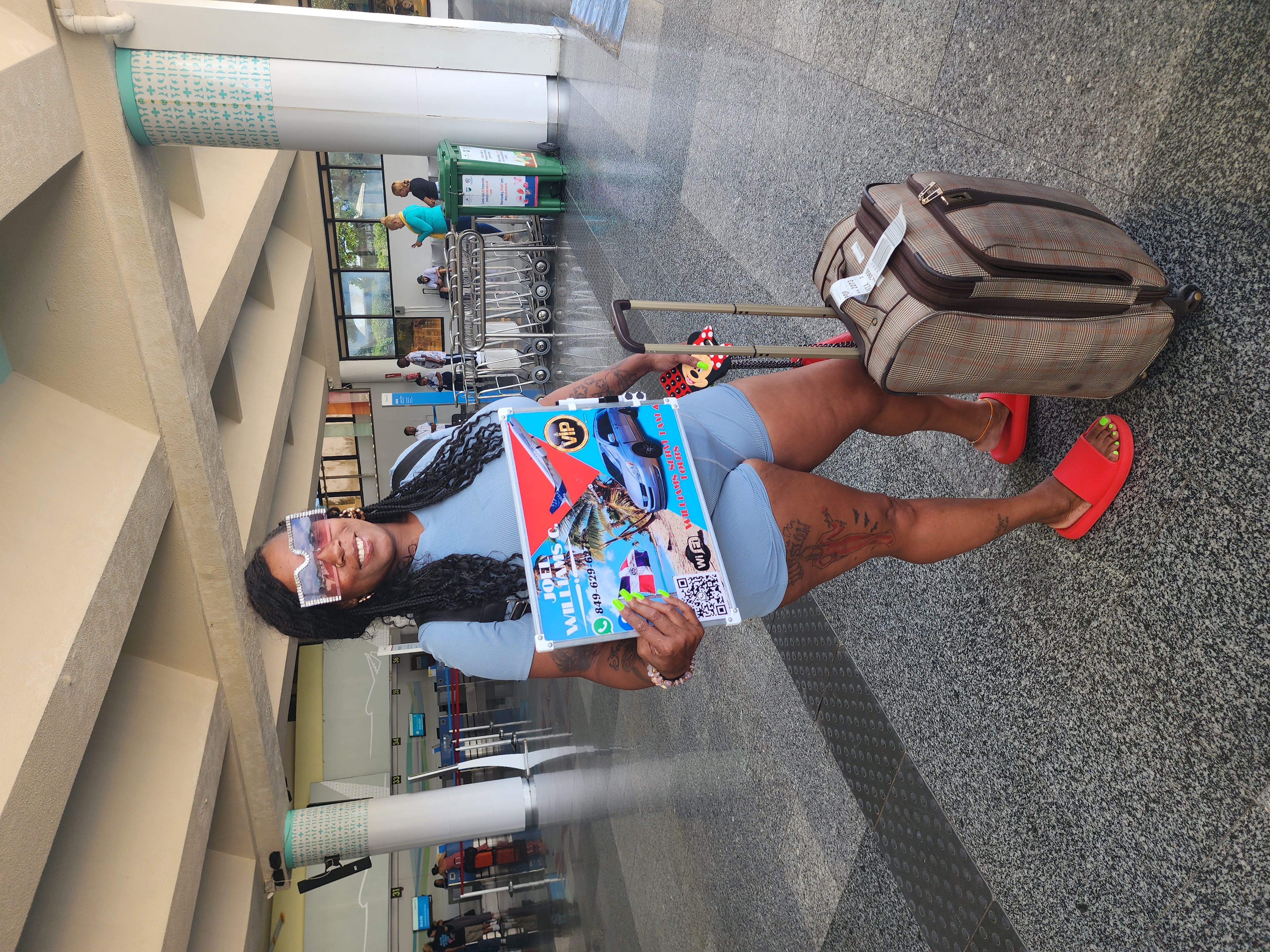 Williams Service Taxi & Tours driver holding a VIP welcome sign at a Dominican Republic airport