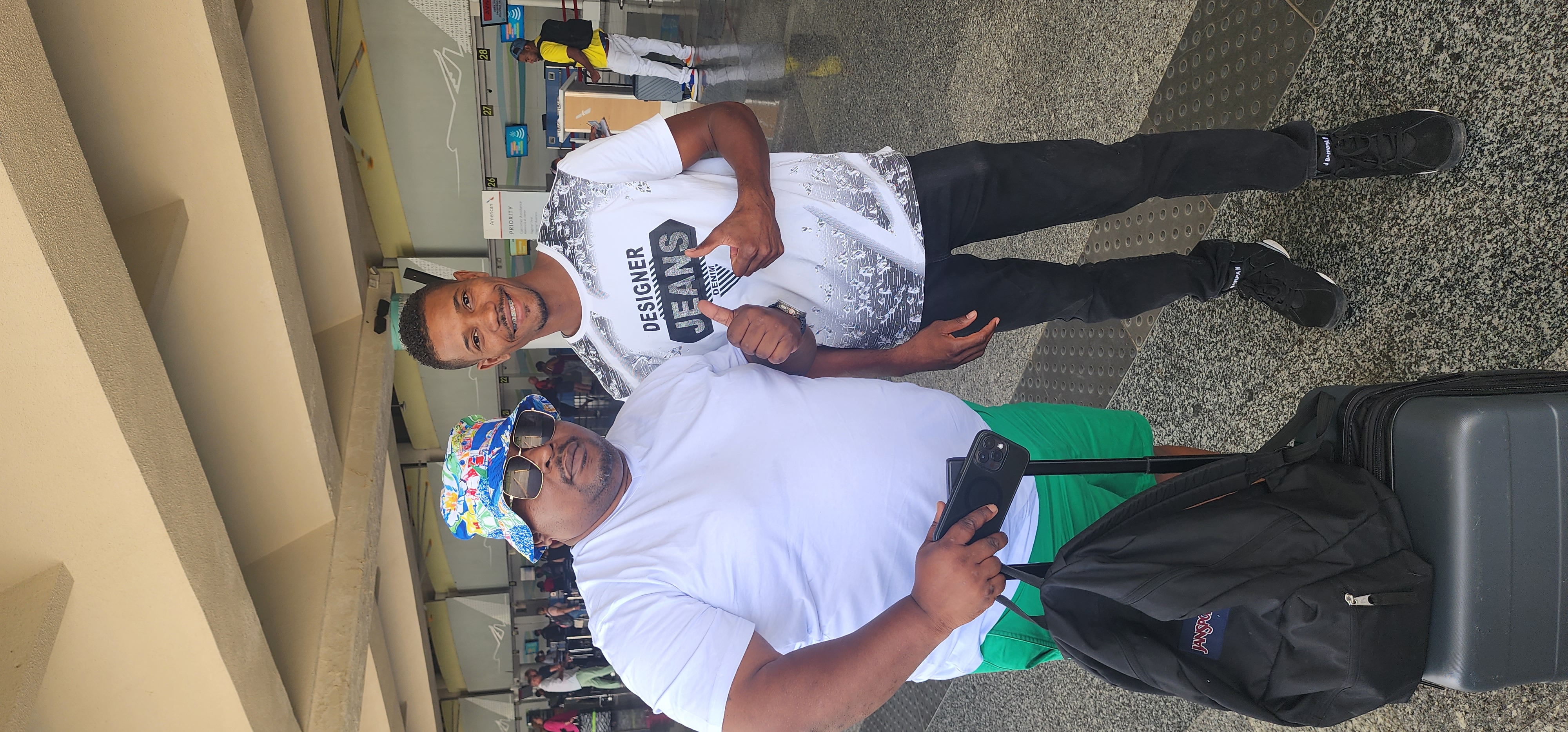 Driver helping passengers with their luggage at airport pickup
