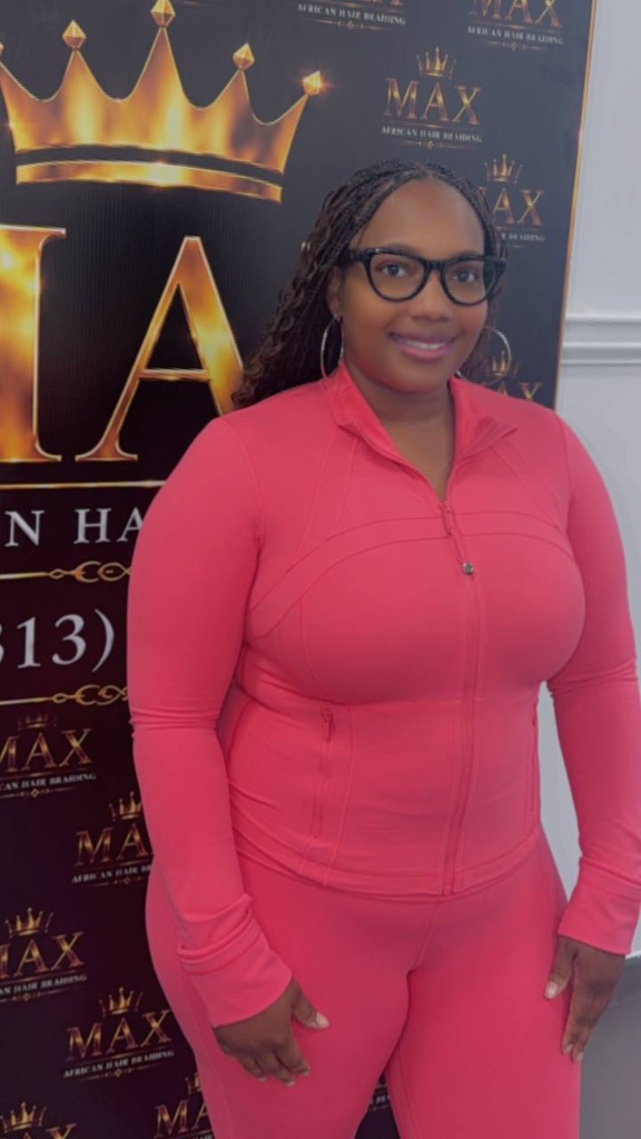 Client with cornrow braids smiling