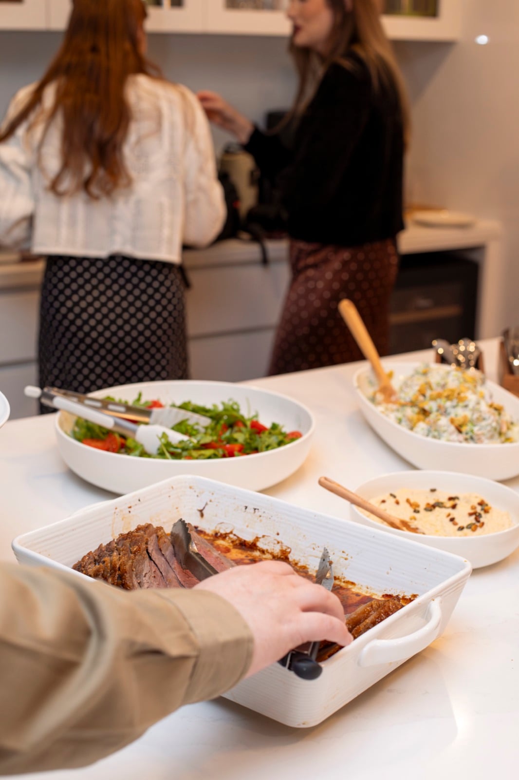 Guests sharing food together at a Come On Over gathering