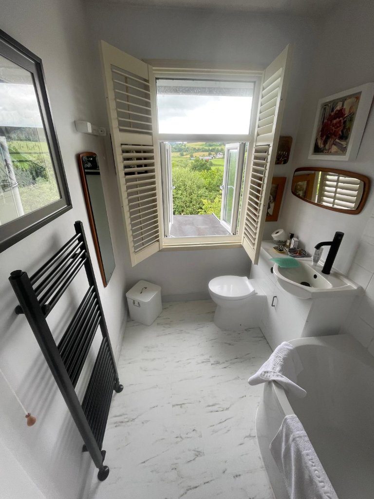Modern Bathroom with Black Accents — bespoke bathroom renovation by JPT Plumbing & Bathrooms in West Wales