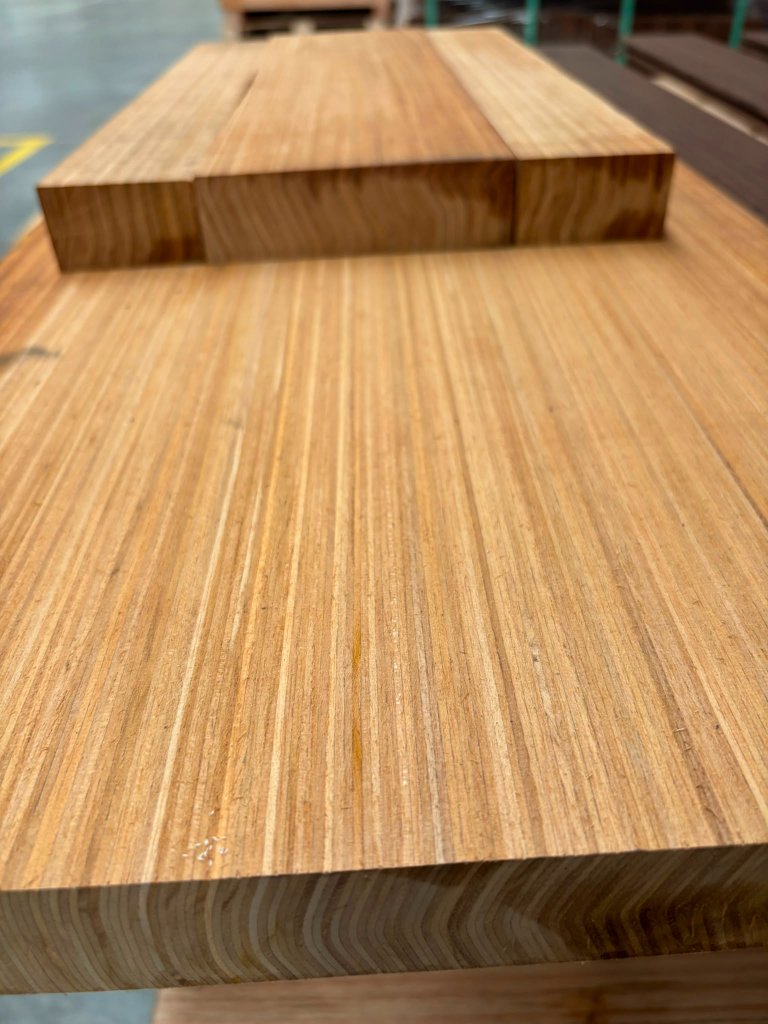 Macro close-up of Grade-A Maritime Teak showing natural oil-rich grain patterns
