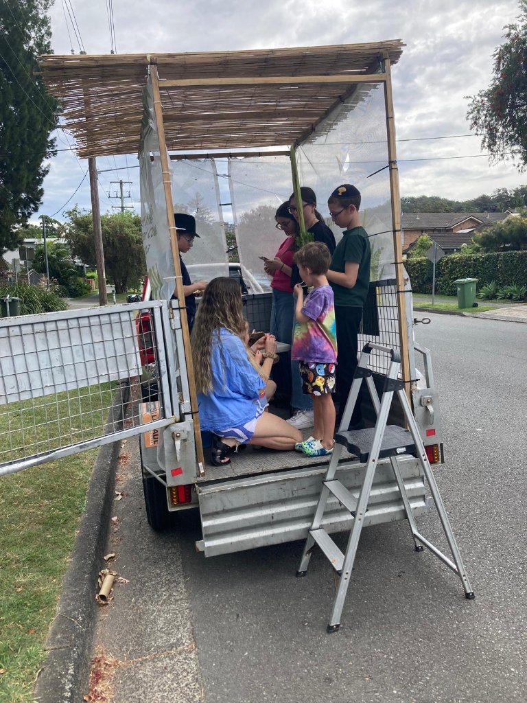 Sukkos in the Park — young members helping with the mobile sukkah