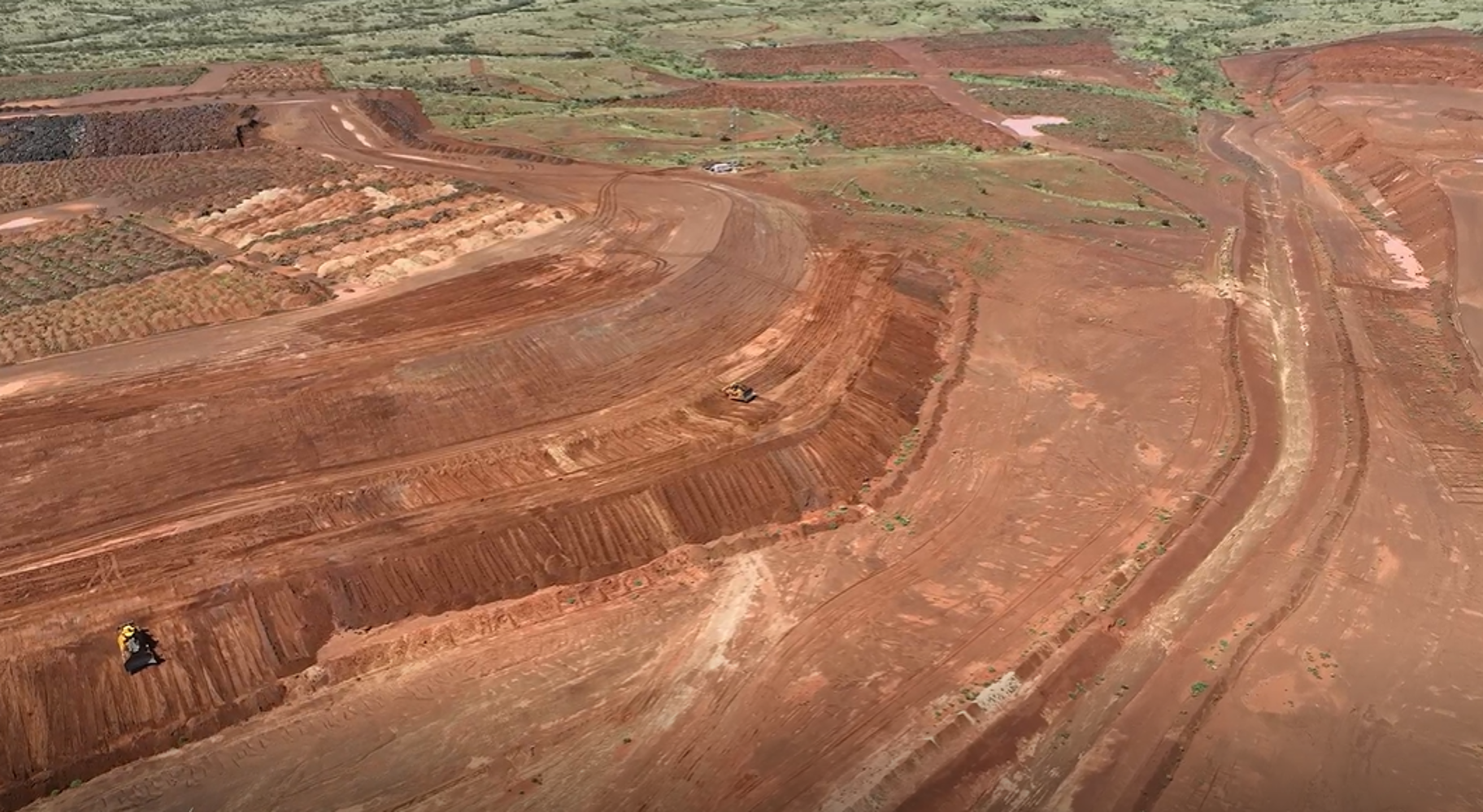 Aerial view of graders working a red dirt platform on a Pilbara earthworks site