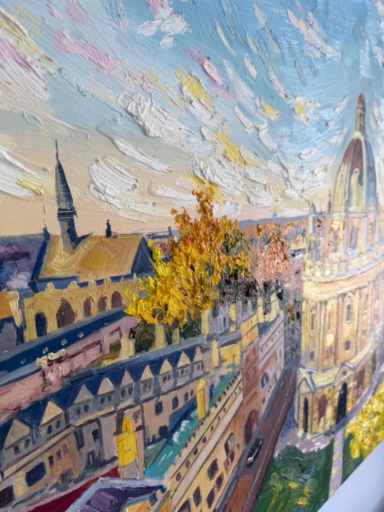 Macro detail of hand-painted oil canvas showing thick brushwork on trees and building facade