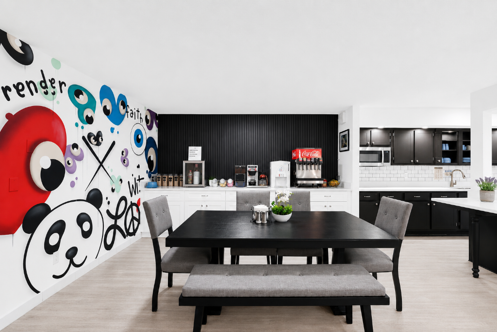 Common area with art mural and dining space
