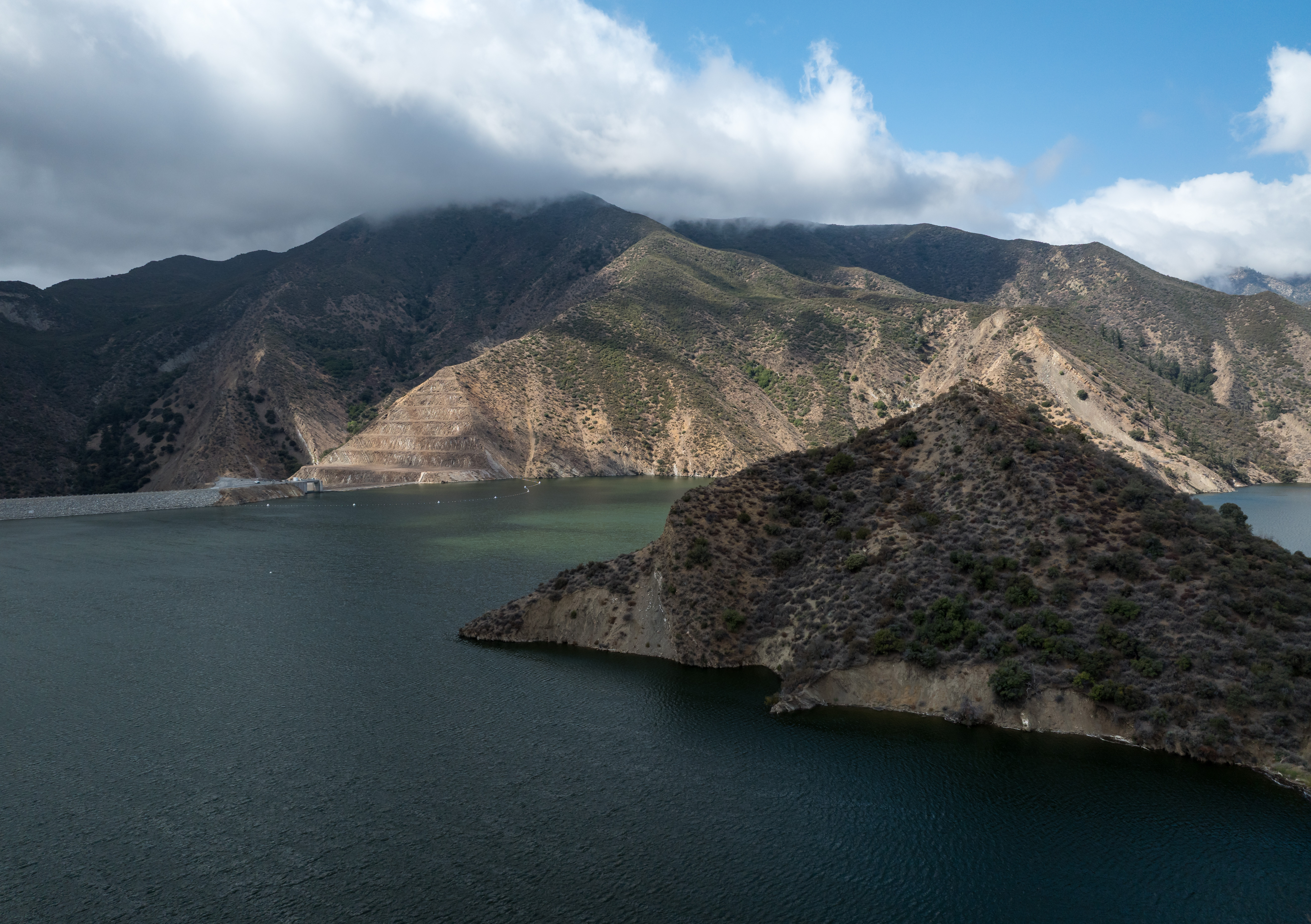 Pyramid Lake surrounded by mountains beneath low clouds