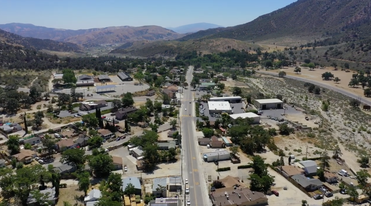 View over Frazier Park, its main road, homes, businesses, and surrounding mountains